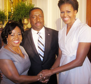 Gregory Calhoun (pictured with his wife) meets First Lady Michelle Obama as part of his efforts to build stores in underserved areas.