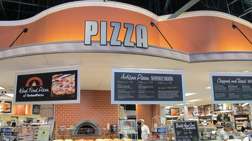 The centerpiece of the store is a massive kitchen featuring a wood-fired pizza oven. 