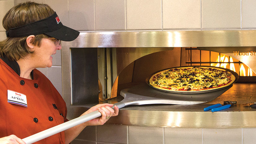 The new store features Woods’ first in-store pizza oven.
