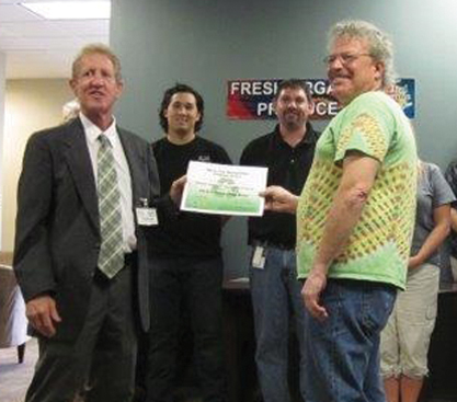 Mitch Blumenthal, top right, founder of Global Organic, receives an award for recycling from the Florida Department of Environmental Protection.