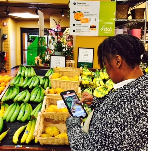 A shopper uses the Fetch Rewards app at Treasure Island in Chicago