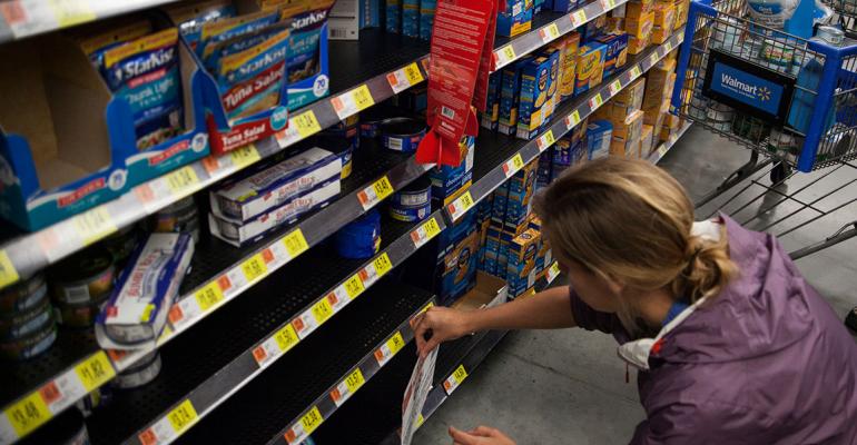 Greenpeace activists affixed signs to Walmart shelves after emptying them of tuna Photo courtesy of Greenpeace