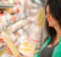 woman checking grocery product.png