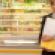 Lady holding bagged groceries in front of dairy case.jpg