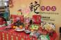 Traditional Lunar New Year gifts and foods are displayed at the front of stores