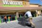 Walmart 2Q earnings dip, outlook trimmed