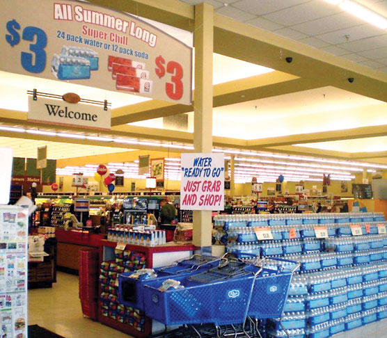 C&K Market displays 24-packs of private-label Super Chill water in otherwise-empty shopping carts for customer convenience.