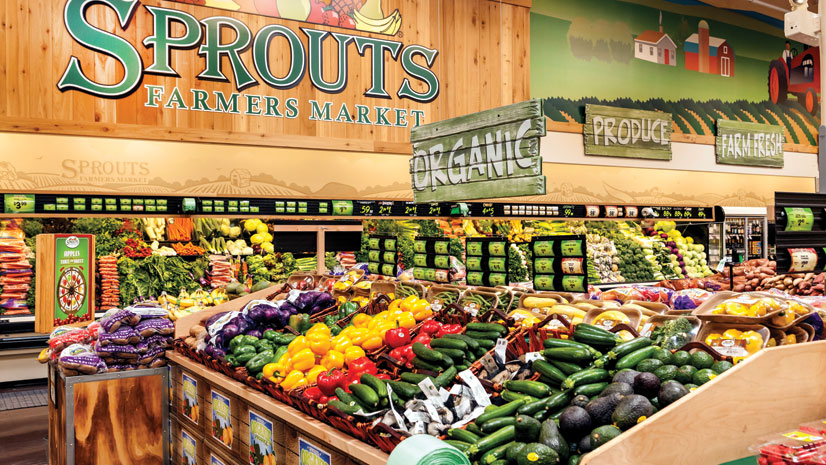 Produce is the focal point of Sprouts stores, where customers are attracted to the selection and value, company executives say. Stores have a farmers’ market ambiance with low shelving for better visibility and to create a bright,  open-air atmosphere.
