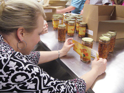 Campbell volunteers labeled 52,000 jars of Just Peachy by hand.