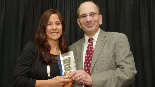Natalie Menza, manger of health and wellness for Wakefern, accepts SNâ€™s 2014 Whole Health Enterprise Award from David Orgel, executive director, content & user engagement.
